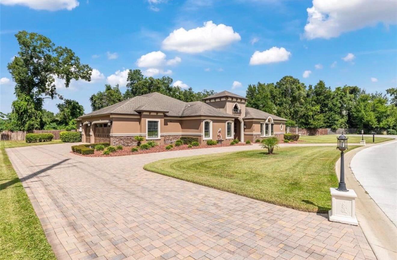 A single-story house with a stone and stucco exterior sits behind a paved circular driveway — 2901 SE 28th Lane, Ocala FL 34471, OCALA, FL