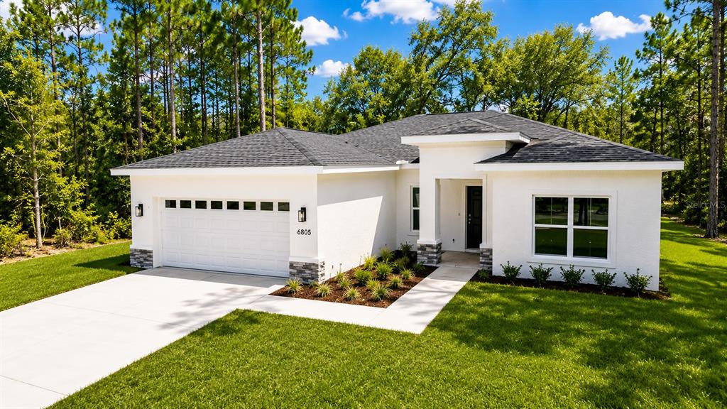 A white single-story house with a two-car garage and a dark shingled roof — 6805 SW 131ST PLACE, OCALA, FL