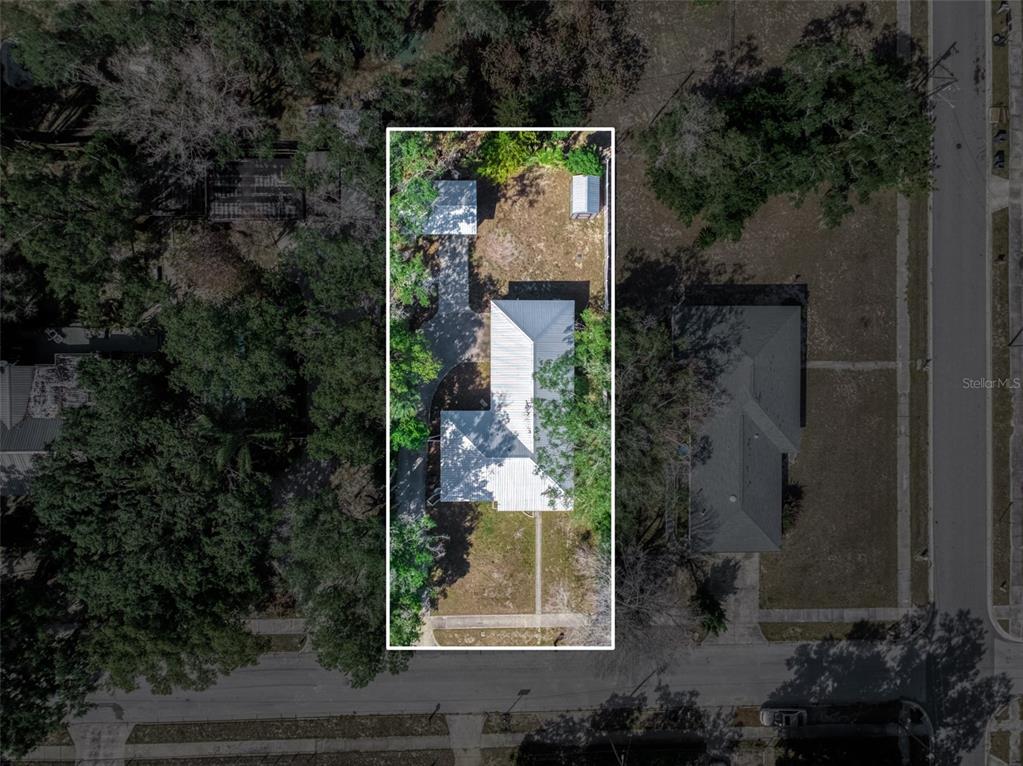 This is an aerial view of a residential property with a house and detached garage — 1018 BELLEVUE AVENUE, SEBRING, FL