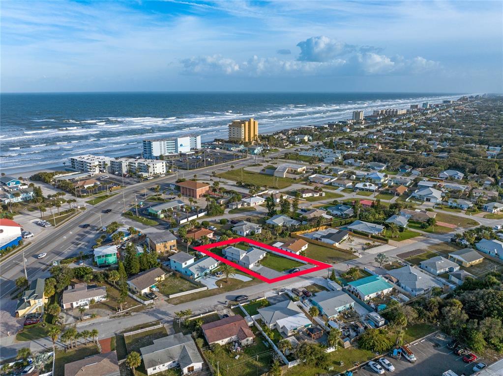 An aerial view shows a single-story house outlined in red within a coastal residential neighborhood — 1409 SOUTHARD AVENUE, NEW SMYRNA BEACH, FL