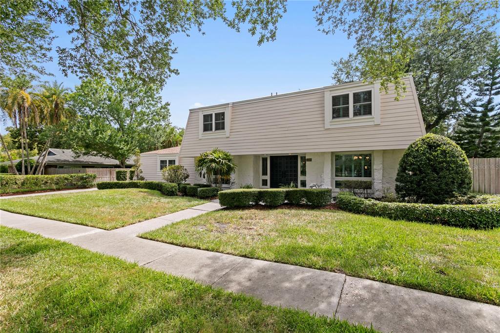 A two-story house with light-colored horizontal siding and a landscaped front yard — 13305 GOLF CREST CIRCLE, TAMPA, FL