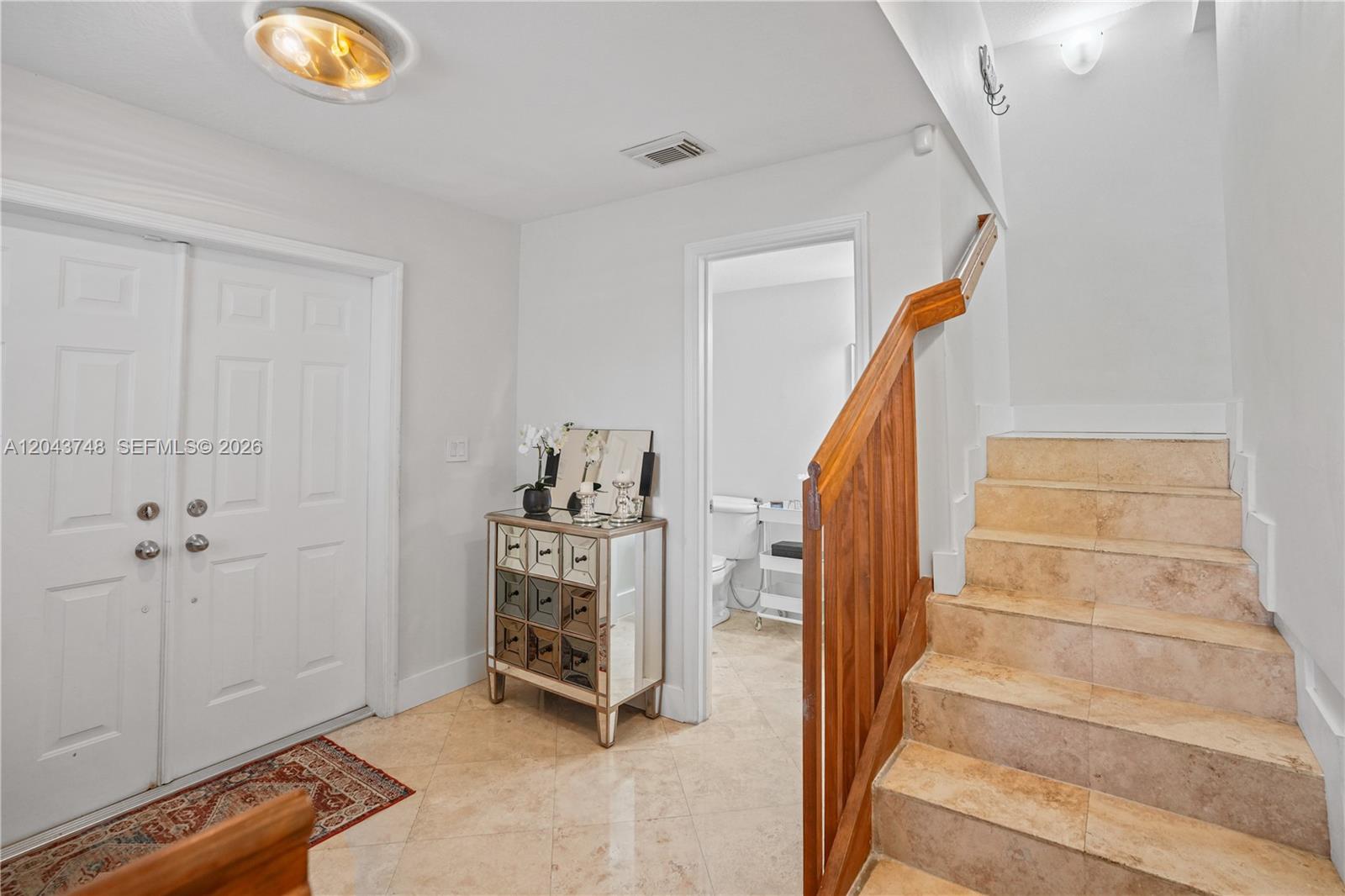 An entryway features a white double door, a mirrored chest, and a tiled staircase — 1043 SW 9th Ct # 1, Miami FL 33130, MIAMI, FL