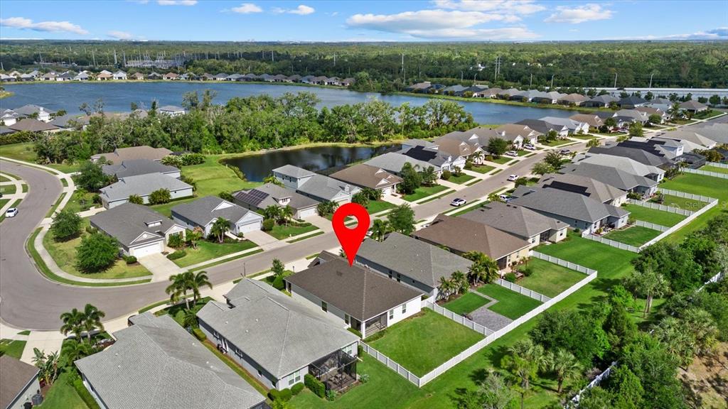 A single-story house with white siding, a gray garage door, and a small dormer window — 7526 RIDGELAKE CIRCLE, BRADENTON, FL