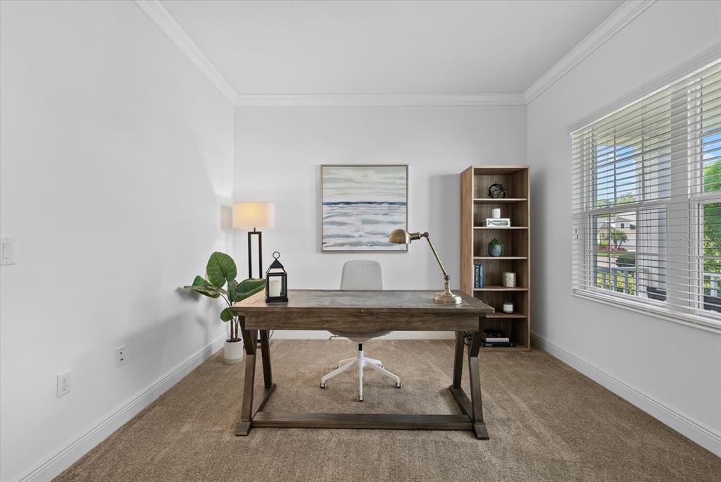 A home office features a wooden desk, a bookshelf, and a window with white blinds — 7526 RIDGELAKE CIRCLE, BRADENTON, FL