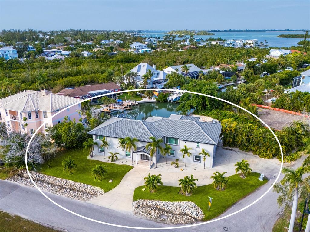 An aerial view shows a two-story house with a gray roof and palm trees — 501 NORTON STREET, LONGBOAT KEY, FL
