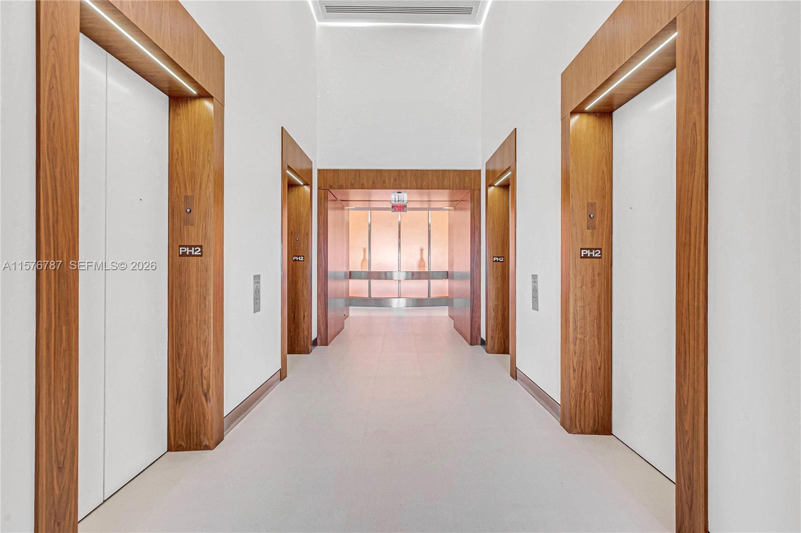 This elevator lobby features white walls, light tile floors, and wood-trimmed door frames — 2020 Ponce De Leon Blvd # A1, Coral Gables FL 33134, CORAL GABLES, FL