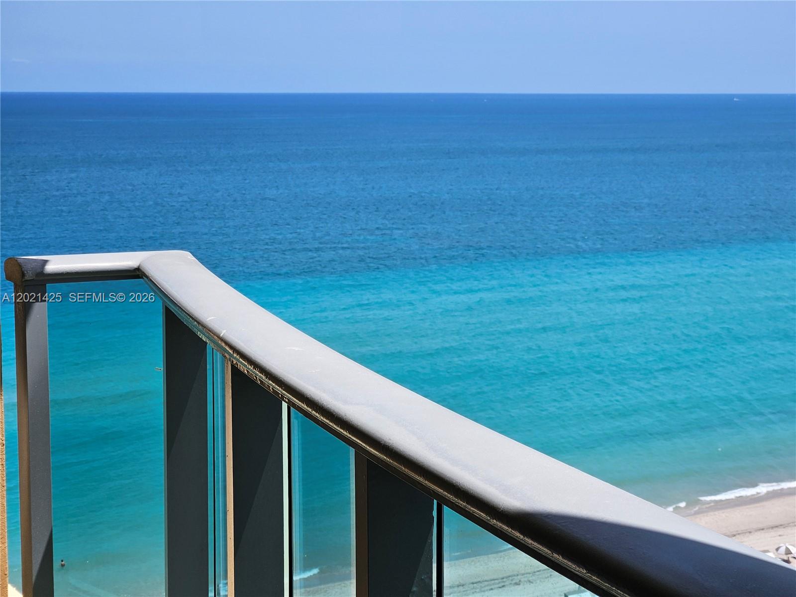 A high-angle view of the ocean from a balcony with a glass railing — 2501 S Ocean Dr, Hollywood FL 33019, HOLLYWOOD, FL