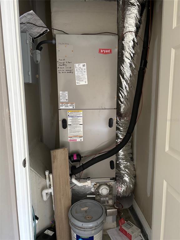 A Bryant HVAC air handler unit is installed inside a small utility closet — 5132 LAND O LAKES BOULEVARD UNIT 105, LAND O LAKES, FL