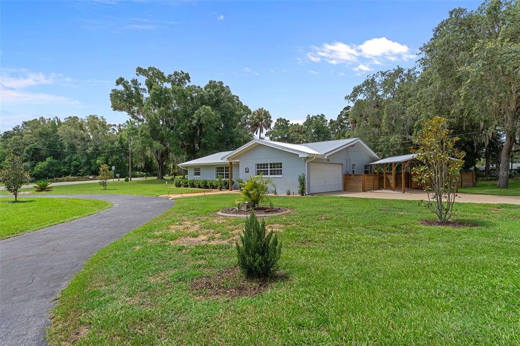 A single-story house with a gray exterior, a garage, and a large front lawn — 914 N MCGOWAN AVENUE, CRYSTAL RIVER, FL