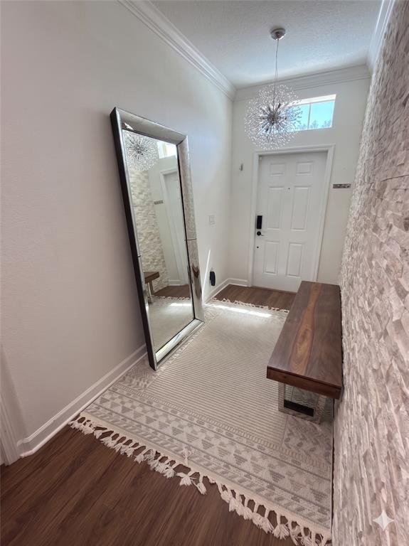 An entryway features a large floor mirror, a wooden bench, and a textured stone wall — 2997 BUCCANEER PALM ROAD, KISSIMMEE, FL