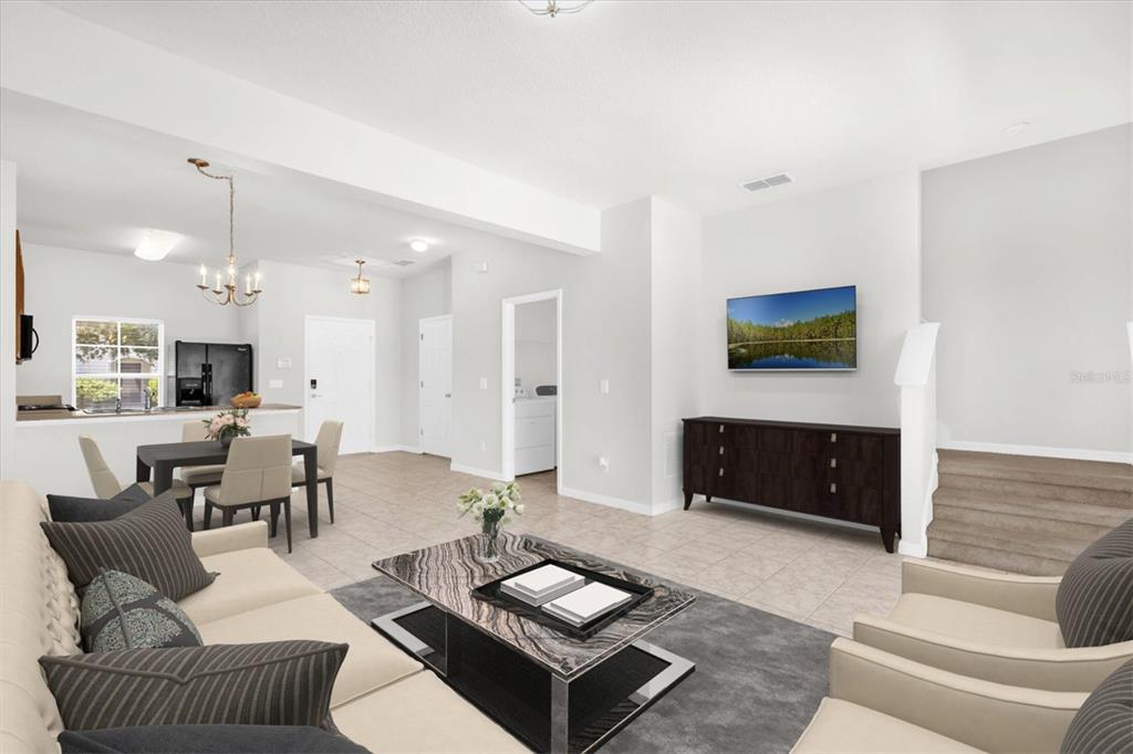 A bright open-concept living and dining area features tile flooring, neutral walls, and modern furniture — 4569 CORSA LANE, KISSIMMEE, FL