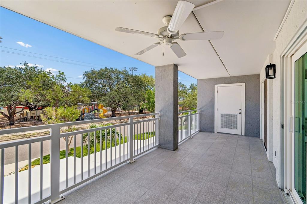 A modern kitchen features white cabinets, stainless steel appliances, and light wood-look flooring — 160 COLUMBIA DRIVE UNIT 206, TAMPA, FL
