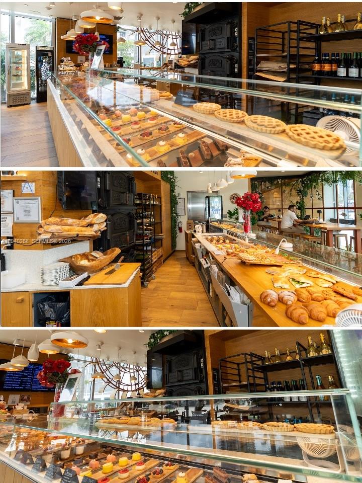 This bakery features glass display cases filled with pastries and breads on wooden counters — 488 NE 18 St, Miami FL 33132, MIAMI, FL