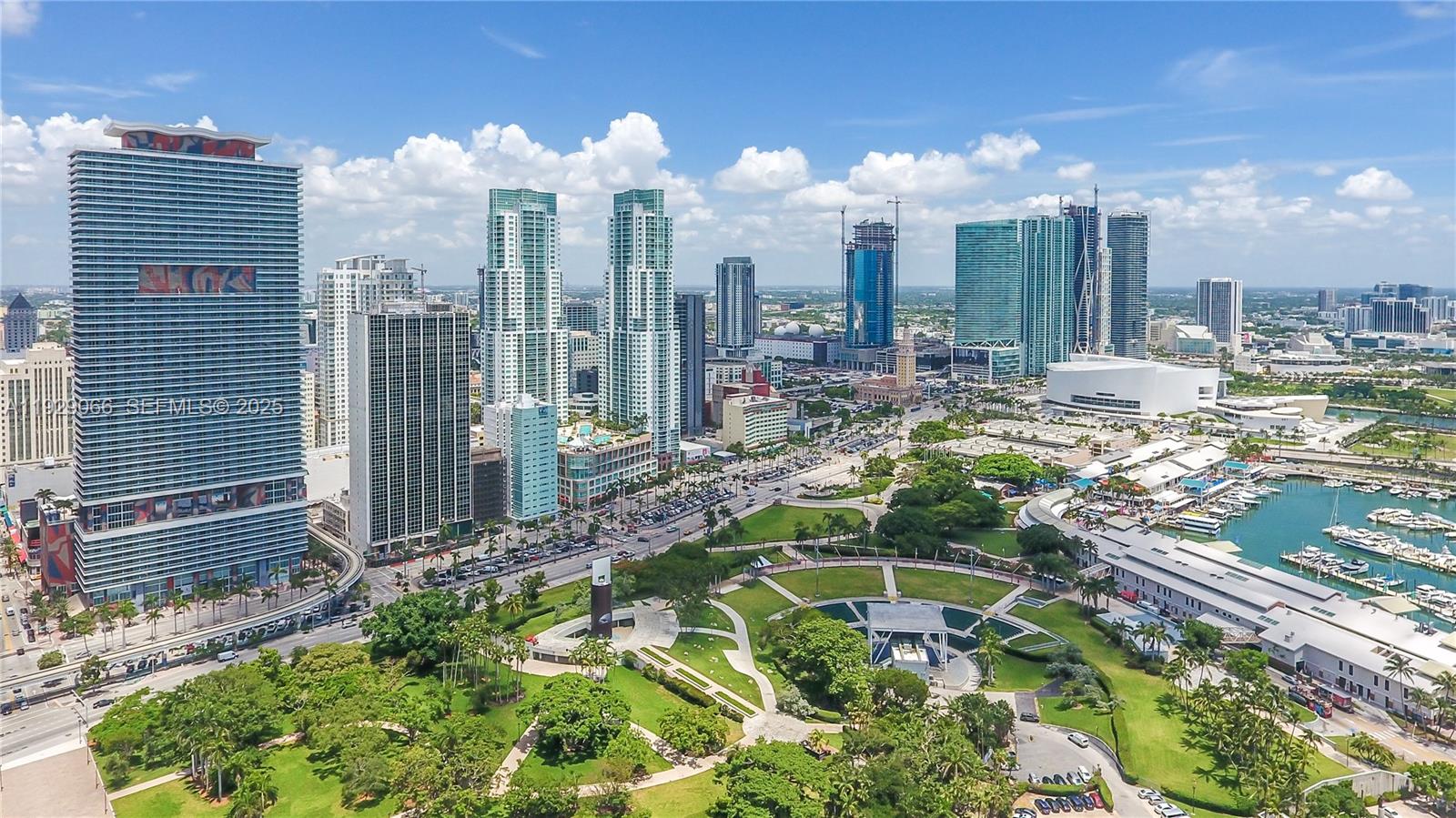An aerial view of the Miami skyline featuring high-rise buildings, a park, and a marina — 50 Biscayne Blvd # 503, Miami FL 33132, MIAMI, FL