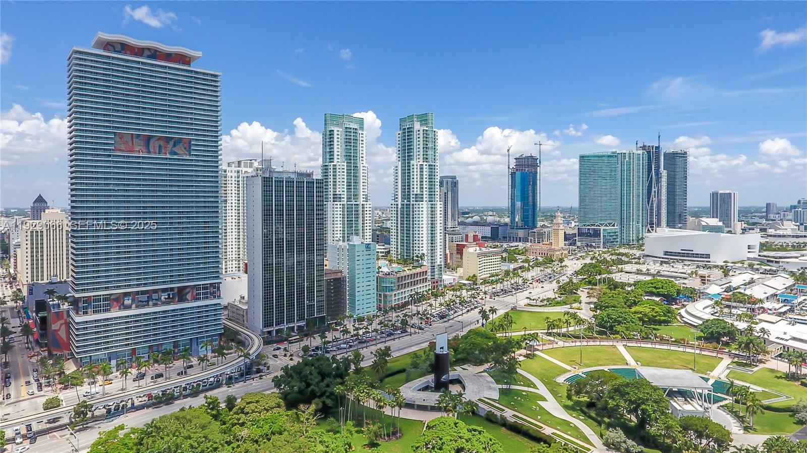 An aerial view of the Miami skyline featuring high-rise buildings, a park, and city streets — 50 Biscayne Blvd # 503, Miami FL 33132, MIAMI, FL
