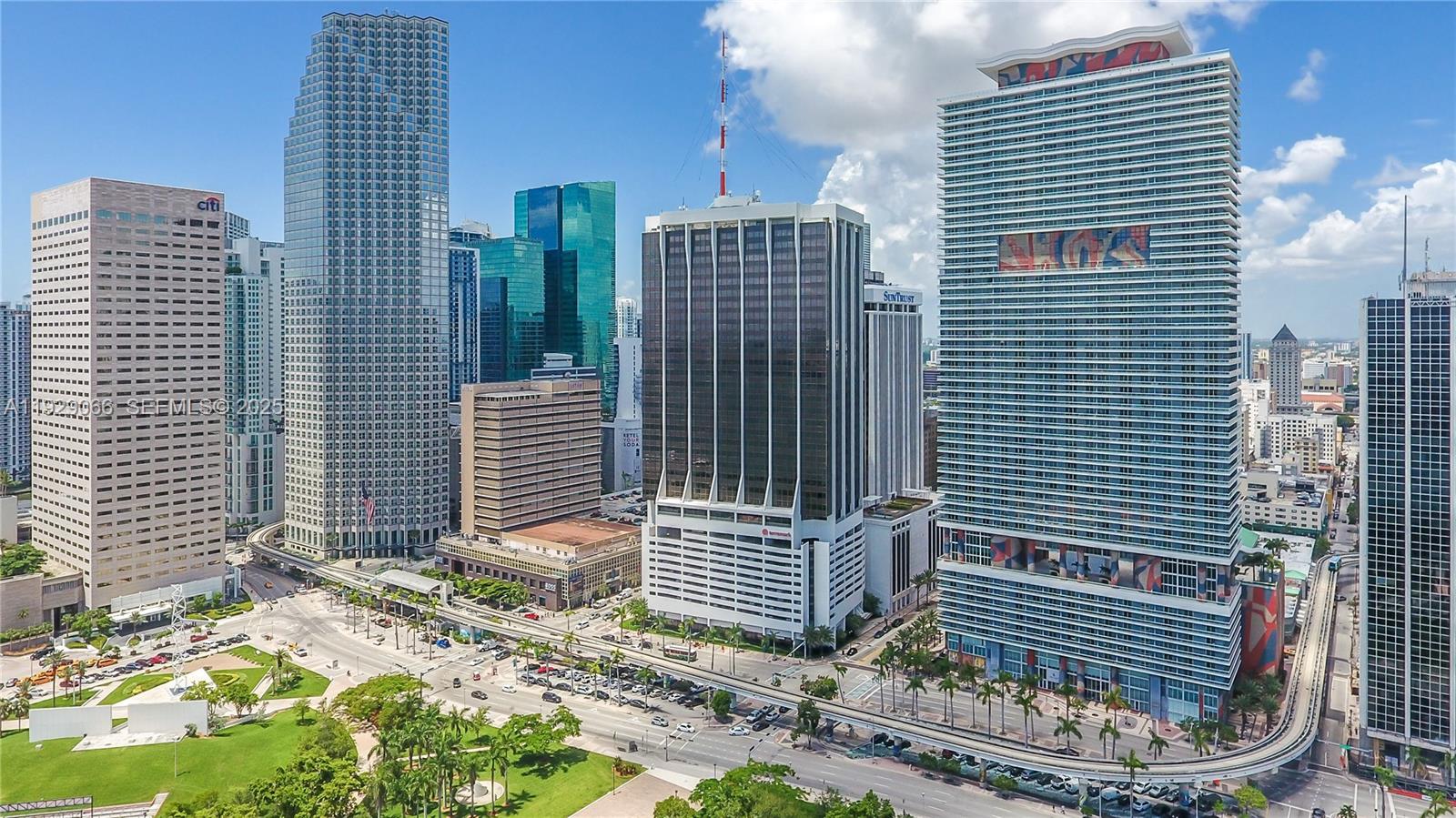 An aerial view of a city skyline featuring several tall skyscrapers and a park — 50 Biscayne Blvd # 503, Miami FL 33132, MIAMI, FL