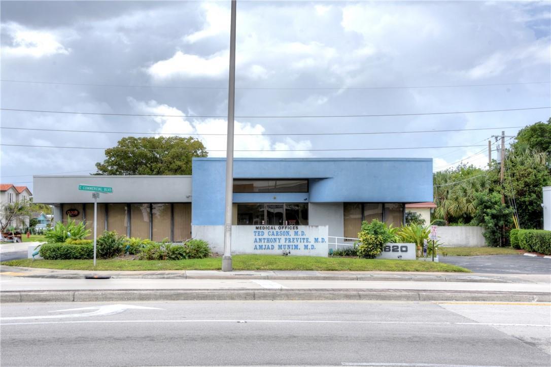 A single-story medical office building with a blue facade and a prominent street sign — 1820 E Commercial Boulevard, Fort Lauderdale FL 33308, FORT LAUDERDALE, FL