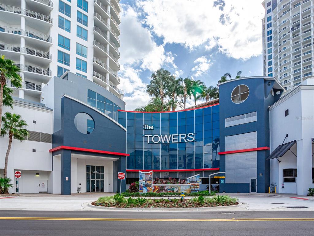 The exterior of a multi-story residential building features a blue curved facade with signage — 449 S 12TH STREET UNIT 1101, TAMPA, FL