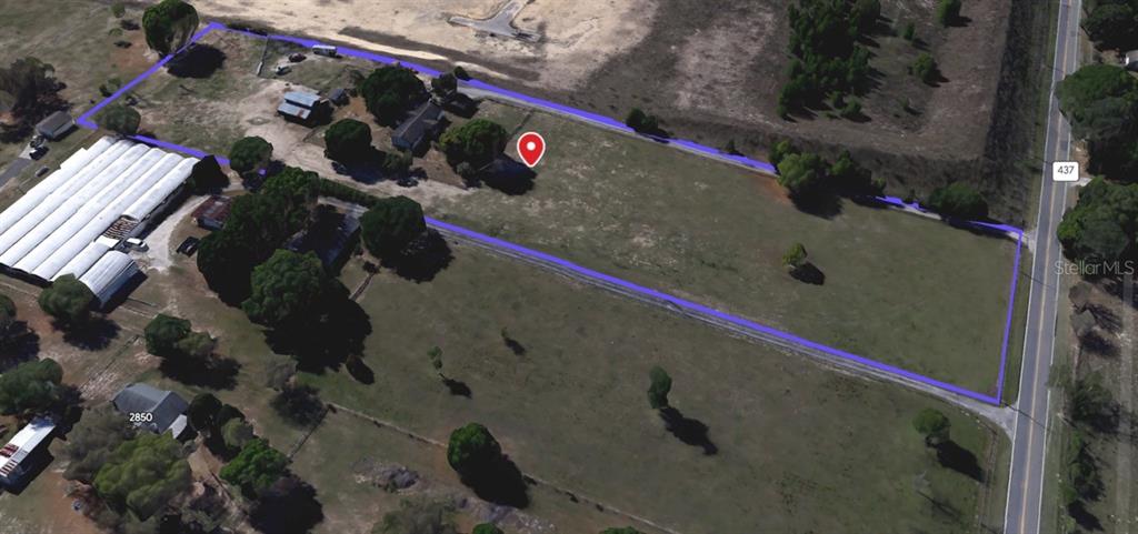 An aerial view shows a large, rectangular plot of land outlined in blue with structures — 5221 PLYMOUTH SORRENTO ROAD, APOPKA, FL