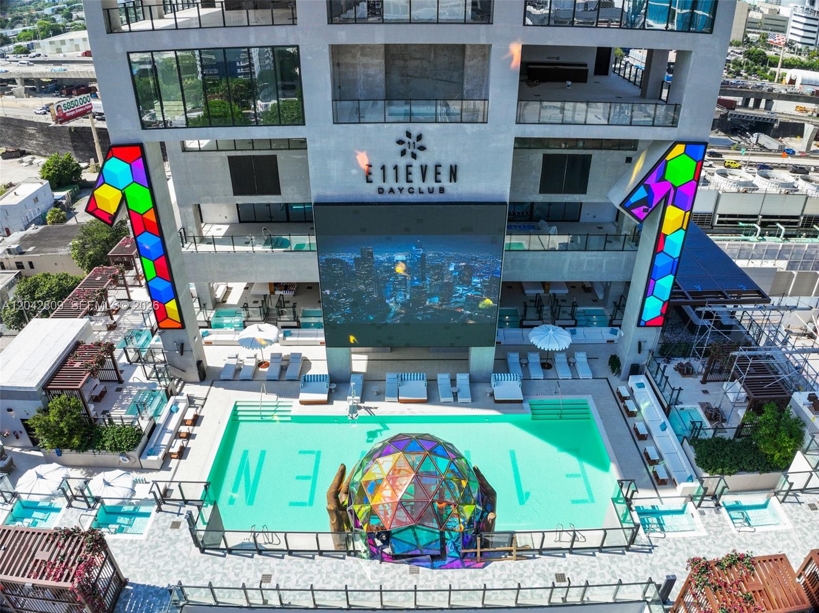 An aerial view of an outdoor pool deck featuring a large dome structure and signage — 20 NE 11 # 2410, Miami FL 33132, MIAMI, FL