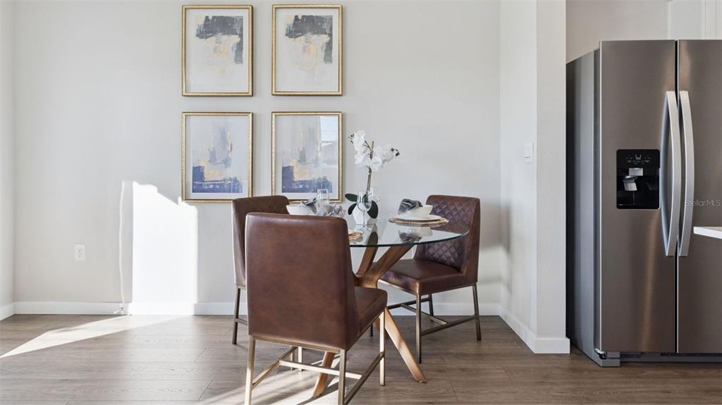 A dining area features a glass-topped table, brown leather chairs, and four framed wall prints — 288 PRESTON COVE DRIVE, ST CLOUD, FL