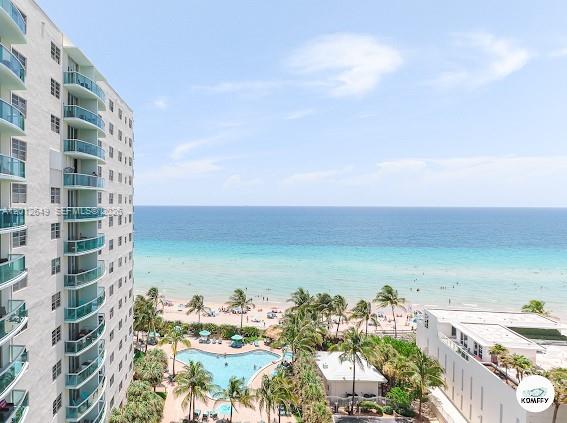 An elevated view of a high-rise building balcony overlooking a swimming pool and the ocean — 3901 S Ocean Dr # 11M, Hollywood FL 33019, HOLLYWOOD, FL