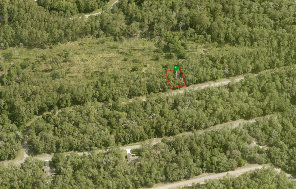 An aerial view shows a rectangular plot of land marked with a red outline — 737 E BYRD LOOP, DUNNELLON, FL