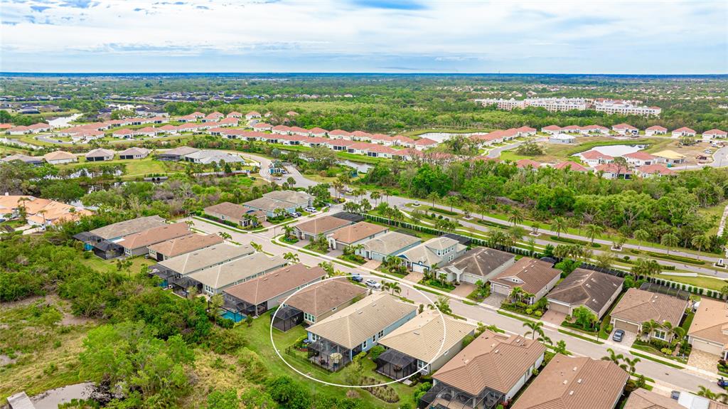 An aerial view shows a residential neighborhood with a circled house featuring a screened lanai — 5416 HOPE SOUND CIRCLE, SARASOTA, FL