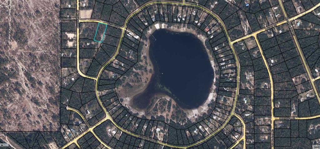 This aerial map shows a vacant residential lot highlighted in blue near a circular lake — 5795 BLUE RIDGE COURT, KEYSTONE HEIGHTS, FL