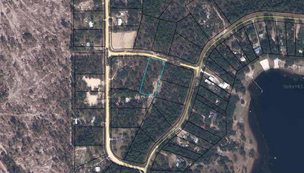 This is an aerial map showing a vacant lot highlighted in blue near a lake — 5795 BLUE RIDGE COURT, KEYSTONE HEIGHTS, FL