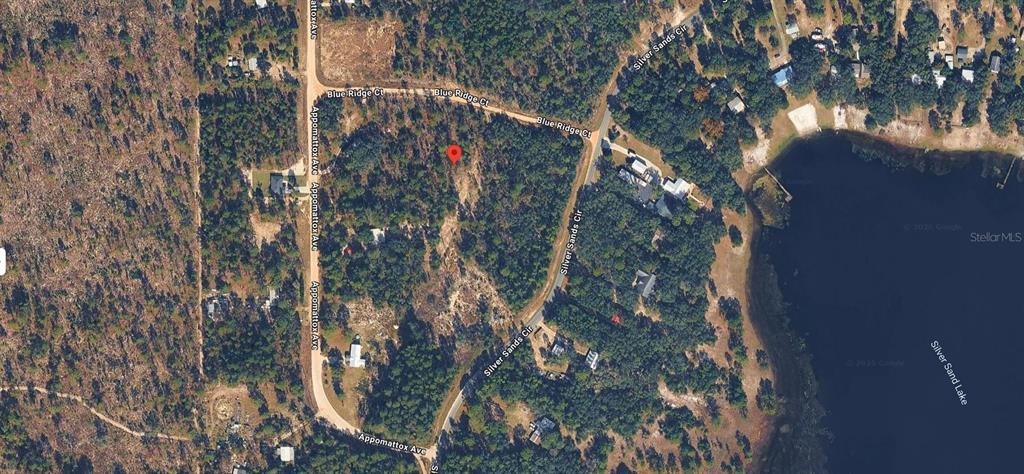 This aerial map shows a wooded residential lot marked with a red pin near a lake — 5795 BLUE RIDGE COURT, KEYSTONE HEIGHTS, FL