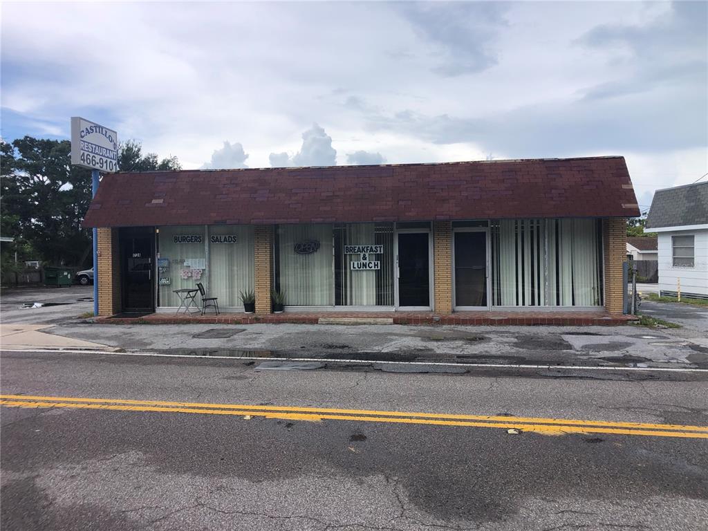 A single-story commercial building with a brick facade and a red shingled roof — 1726 N FORT HARRISON AVENUE, CLEARWATER, FL