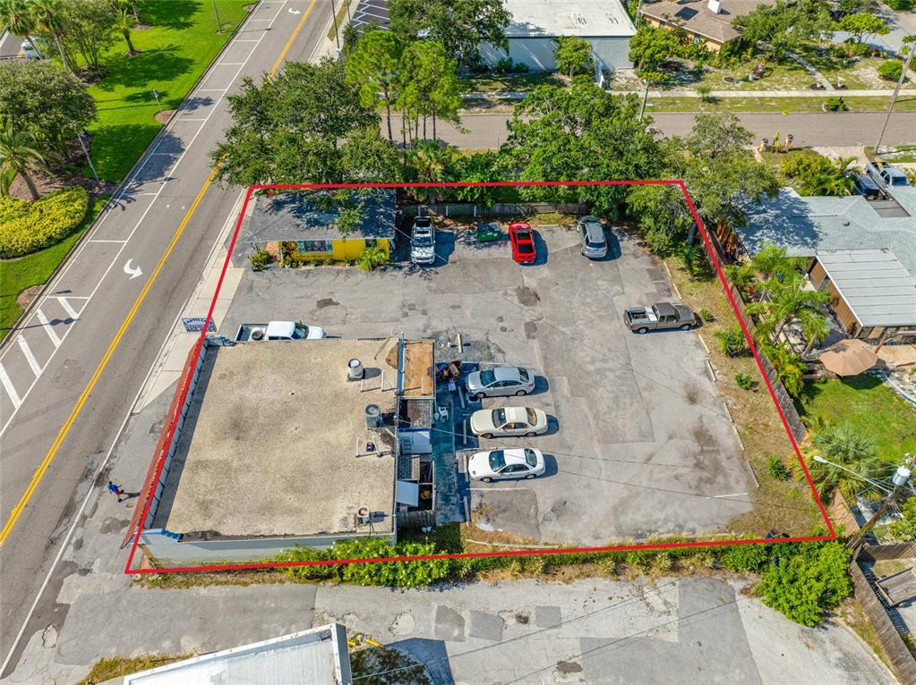 An aerial view shows a commercial building with a large parking lot outlined in red — 1726 N FORT HARRISON AVENUE, CLEARWATER, FL
