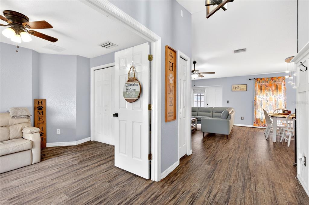 A living room and dining area feature light gray walls and wood-look laminate flooring — 45 LARCH RADIAL, OCALA, FL
