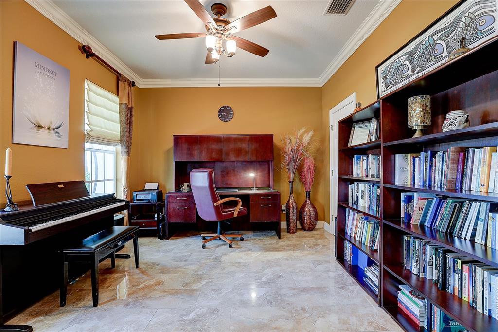 A home office featuring a desk, a piano, and a tall bookshelf on tiled floors — 5518 LUMINAR POINTE LANE, APOLLO BEACH, FL