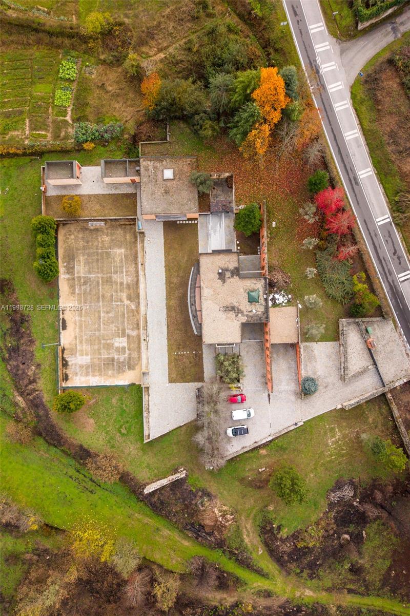 An aerial view shows a house with a tennis court, parking area, and surrounding landscape — Numero 56 E Estrada Nacional 323,Moimenta da Beira, PT 3620, PT