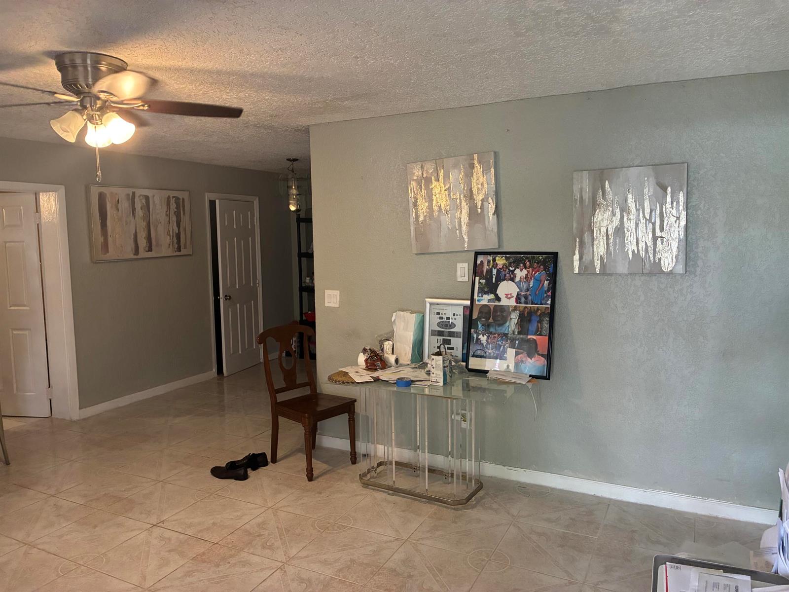A living room features light gray walls, tile flooring, a ceiling fan, and wall art — 3120 NE 8th Avenue, Pompano Beach FL 33064, POMPANO BEACH, FL