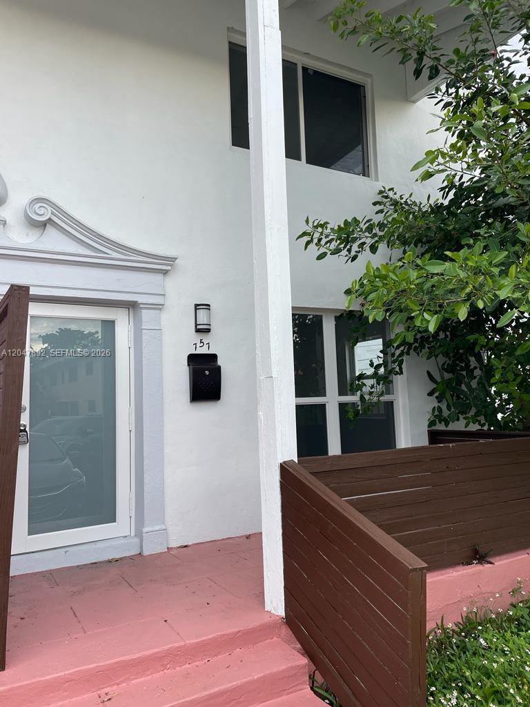 The exterior of a white building features a glass front door, a black mailbox, and stairs — 757 85th St, Miami Beach FL 33141, MIAMI BEACH, FL