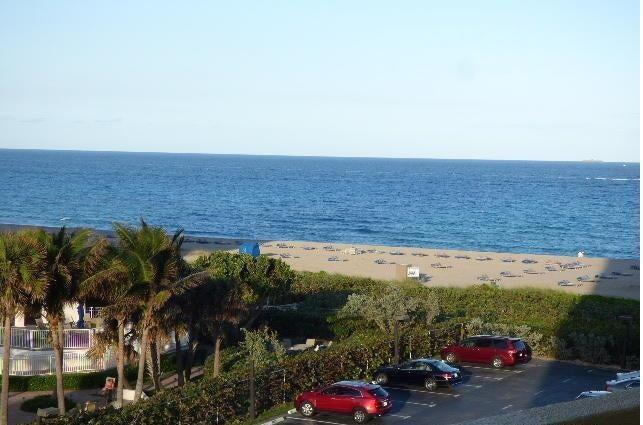 An elevated view of a beach, ocean, and a parking lot with several cars — 2800 N Ocean Drive # 5c, Singer Island FL 33404, SINGER ISLAND, FL
