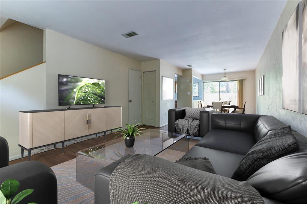 A living room features a black leather sectional, a glass coffee table, and a TV console — 4314 NW 41ST LANE UNIT 73, GAINESVILLE, FL
