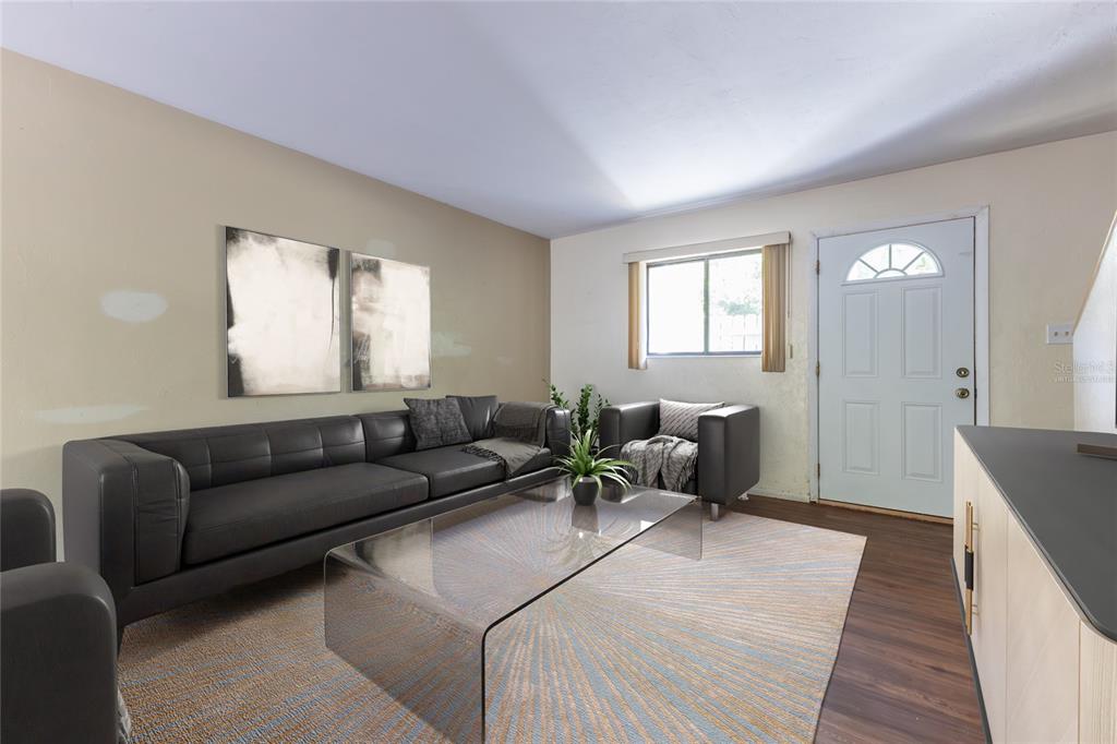 A living room features a dark leather sofa, glass coffee table, and a white front door — 4314 NW 41ST LANE UNIT 73, GAINESVILLE, FL