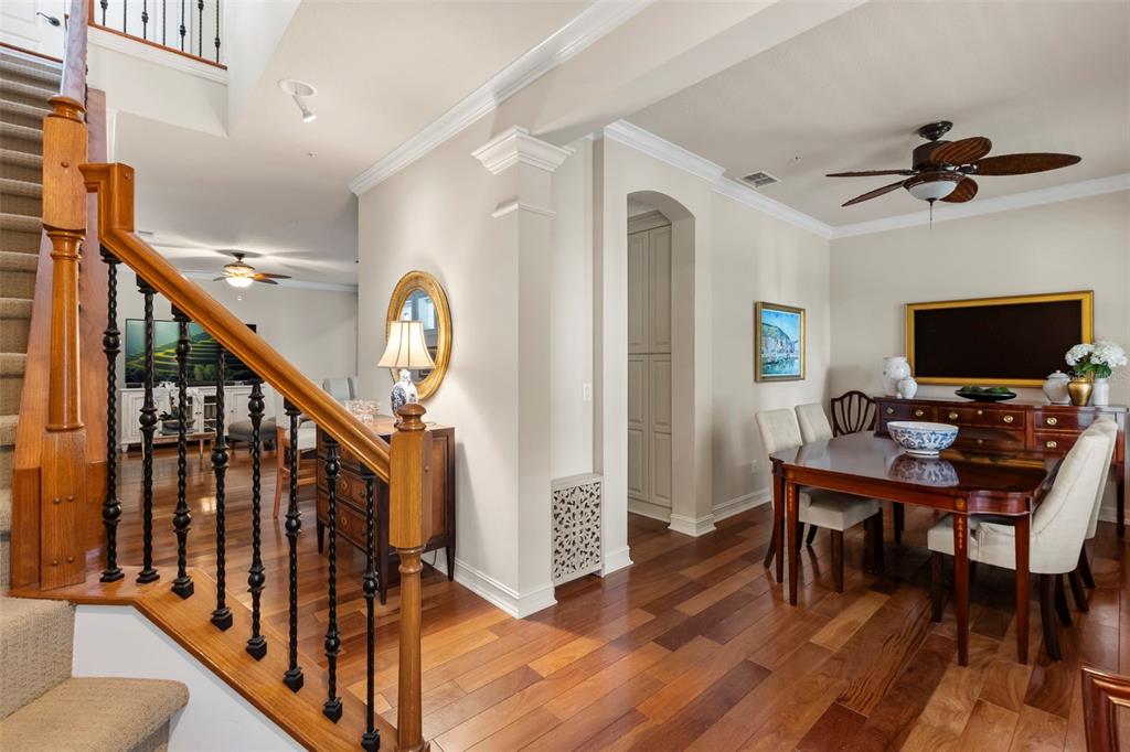 A front porch features a black door, two white rocking chairs, and potted palm plants — 5492 PENWAY DRIVE, ORLANDO, FL
