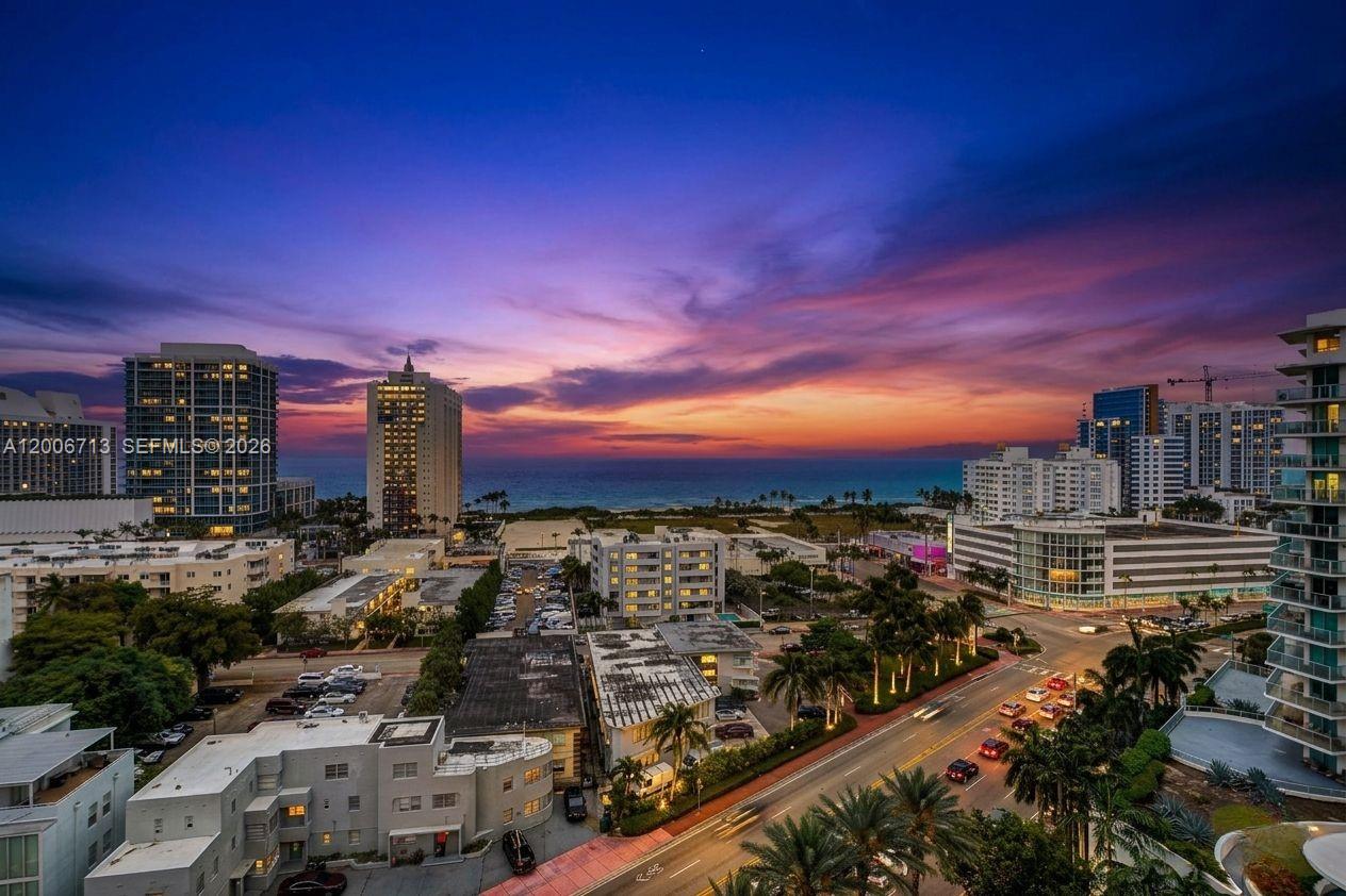 An elevated view of a coastal city skyline at sunset with buildings and a road — 6770 Indian Creek Dr # 14C, Miami Beach FL 33141, MIAMI BEACH, FL