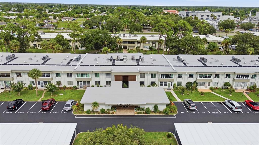 An aerial view shows the exterior of a multi-story apartment building with a covered entrance — 21300 BRINSON AVENUE UNIT 201, PORT CHARLOTTE, FL