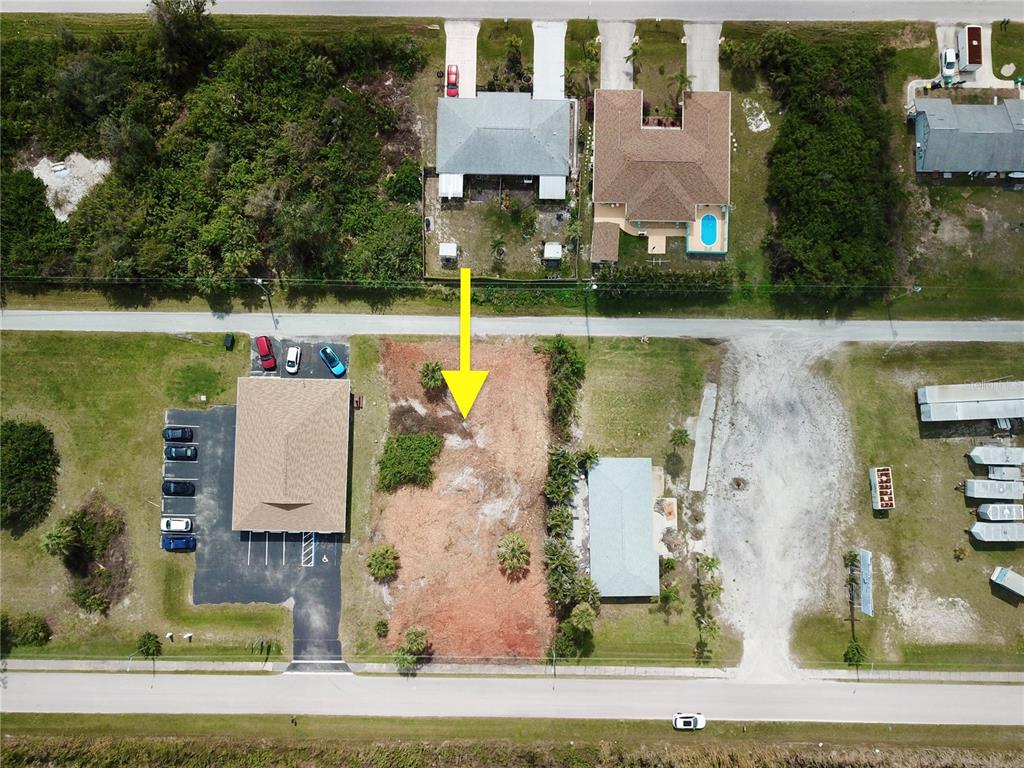 An aerial view shows a vacant, cleared rectangular lot situated between two existing buildings — 4303 & 4307 S ACCESS ROAD, ENGLEWOOD, FL