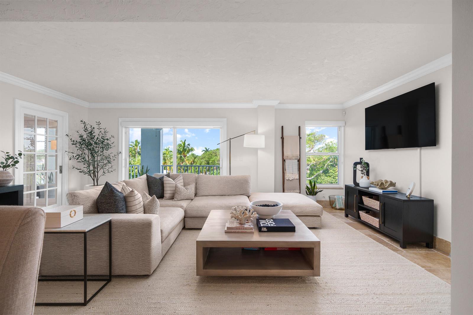 A bright living room features a large sectional sofa, a coffee table, and a television — 1111 S Ocean Boulevard # 417, Boca Raton FL 33432, BOCA RATON, FL