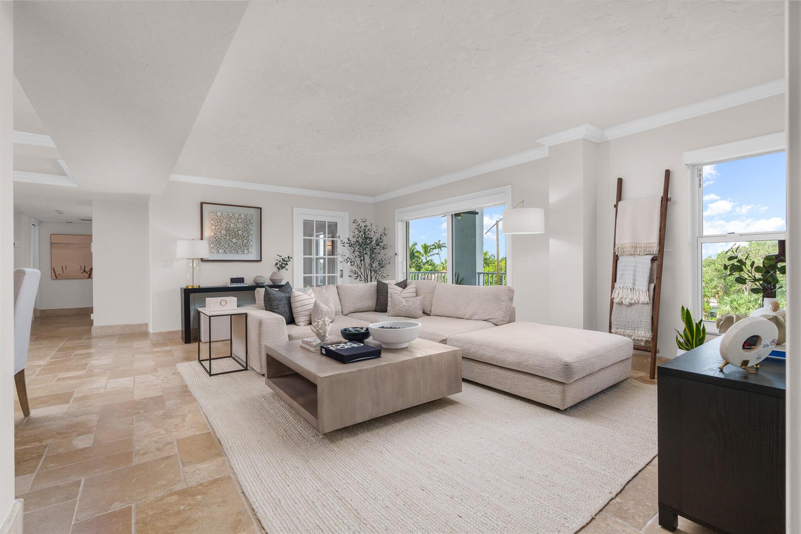 A bright living room features a beige sectional sofa, a wooden coffee table, and tile flooring — 1111 S Ocean Boulevard # 417, Boca Raton FL 33432, BOCA RATON, FL