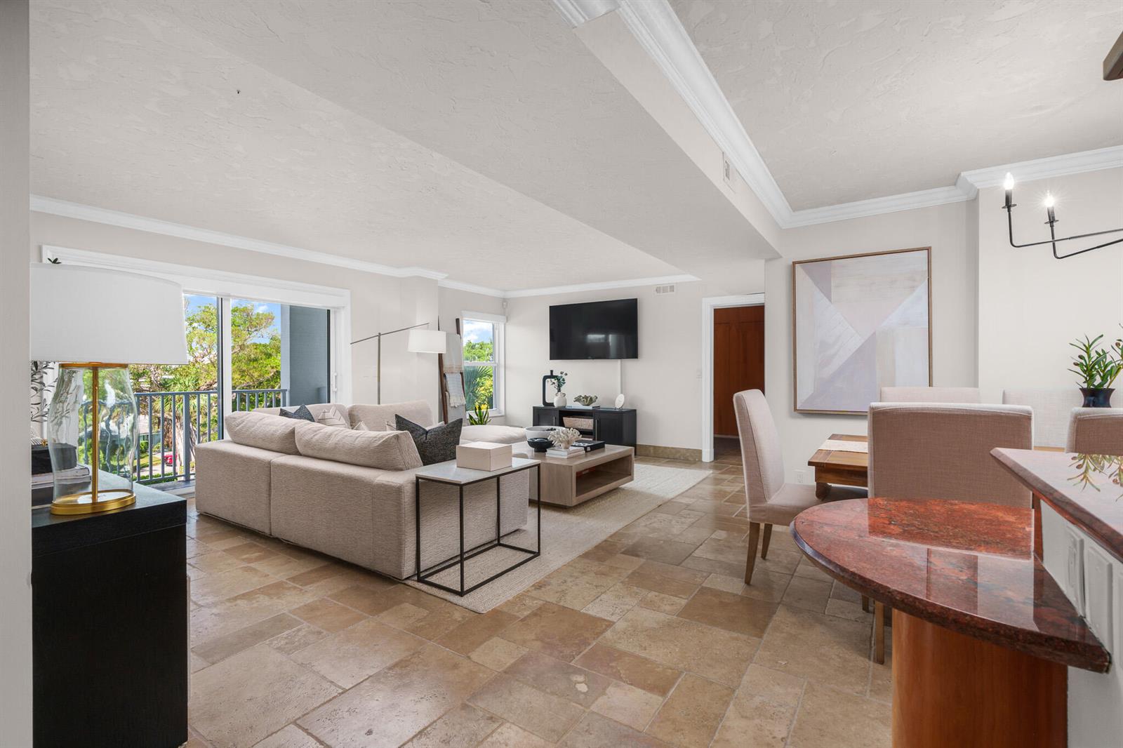 A living and dining area with tile floors, a sectional sofa, and a balcony view — 1111 S Ocean Boulevard # 417, Boca Raton FL 33432, BOCA RATON, FL