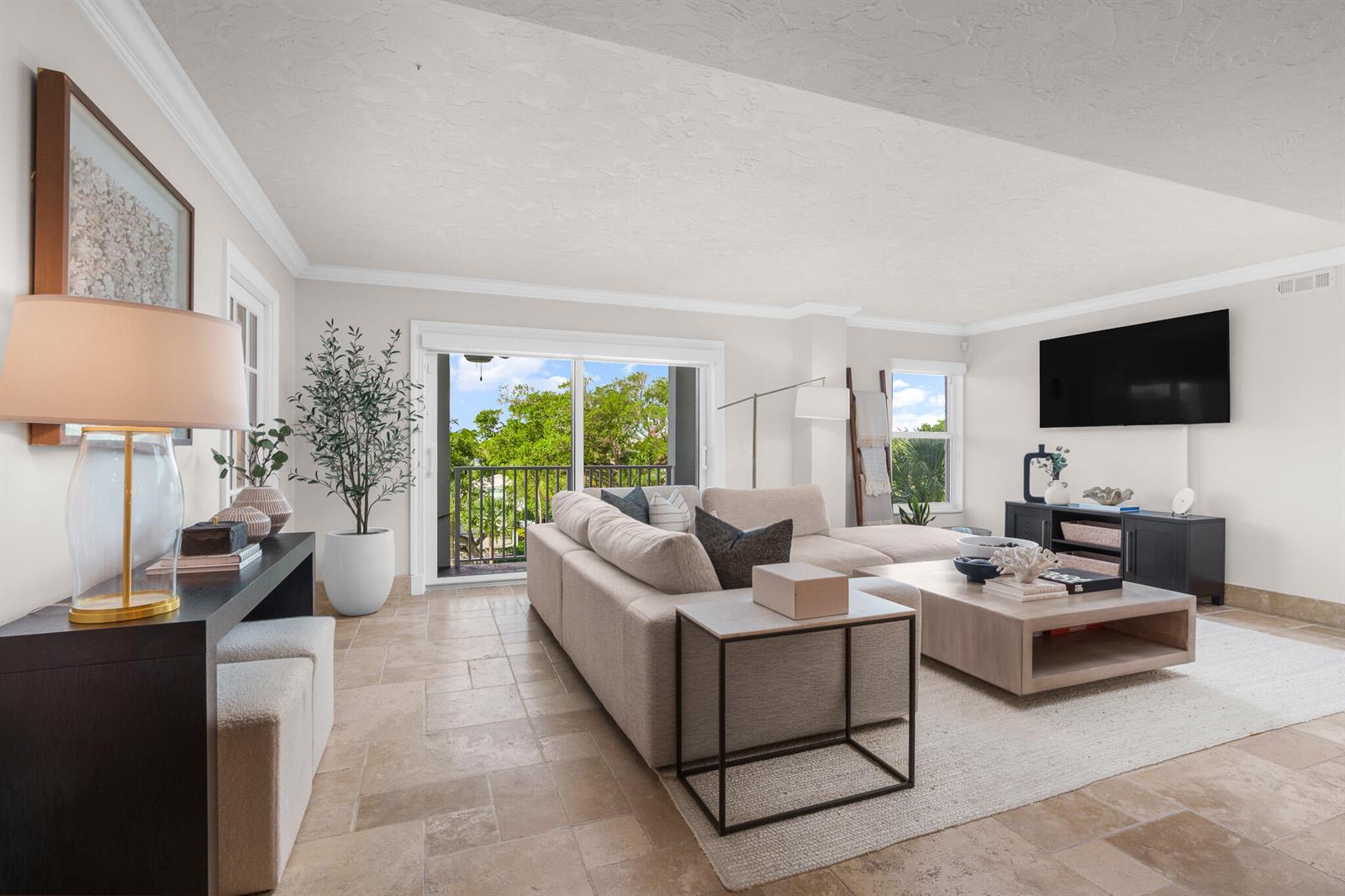 A living room features a large sectional sofa, a coffee table, and tile flooring — 1111 S Ocean Boulevard # 417, Boca Raton FL 33432, BOCA RATON, FL