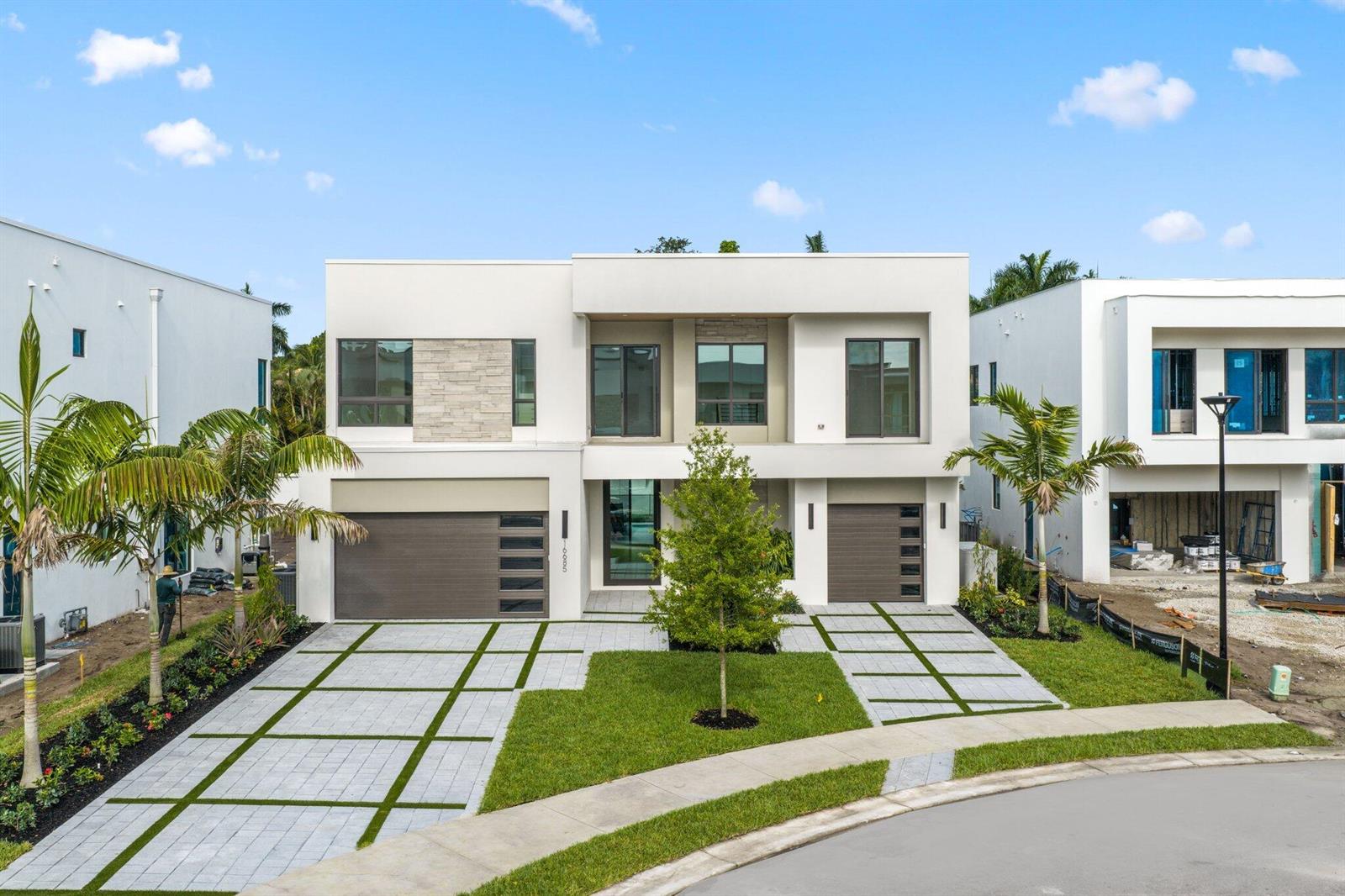 A modern two-story house with a two-car garage, stone accents, and a paved driveway — 16702 Mosaic Place, Delray Beach FL 33446, DELRAY BEACH, FL